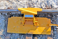 4014-13 Derails - Hinged 
Weld Base Plate to 3 steel ties to provide foundation for bolting one-way or two-way hinged derail. No alteration of track is necessary. Base plate is designed to accommodate Pandrol clips. (Derail is not included with base plate, order separately.)